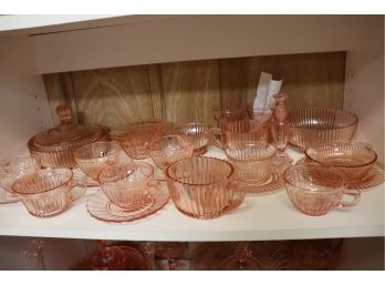 LARGE COLLECTION OF PINK DEPRESSION GLASS INCLUDES COVERED DISH, CUPS, SAUCERS, SUGAR AND CREAMER