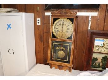 ANTIQUE REGULATOR WALL CLOCK BY GILBERT CLOCK CO.IN A CARVED WOOD CASE WITH PENDULUM & HALF MOON DIAL