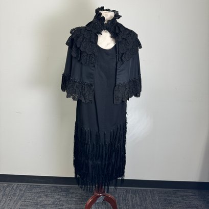 True Black Sleeveless Dress With Swinging Tassels And Lined Cape