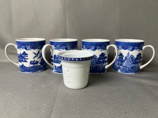 4 Blue And White Asian Design Mugs With A Porcelain Tea Strainer.