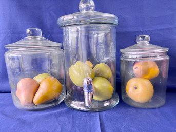 2 Glass Storage Containers And A Glass Carboy With Plastic Fruit.