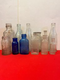 Lot Of 12 Vintage Embossed Bottles
