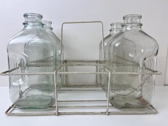 4 Vintage 1/2 Gallon Glass Milk Jugs And A Wire 6 Bottle Carrier.