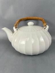 White Porcelain Teapot With Wicker Handle.