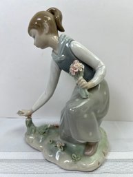 Lladro Waif Picking Flowers.