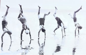 Large Picture Of Women Doing Handstands On The Beach.