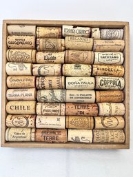 Various Wine Corks Attached To A Box.