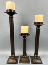 3 Pedestal Candle Holders With Candles.