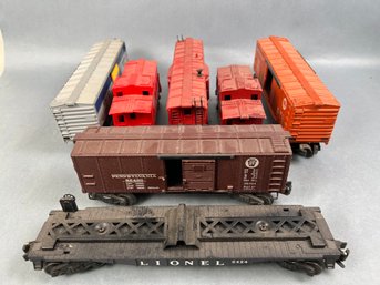5 Lionel Freight Cars And 2 Cabooses.