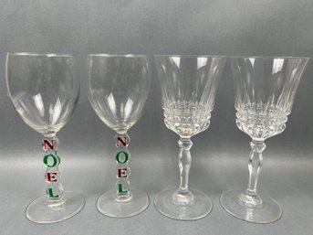 2 Christmas Themed Wine Glasses And 2 Crystal Wine Glasses.