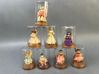 8 Small Resin Angels In Plastic Display Cases.