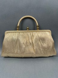 Gold Clutch With Gold Handle And Ball Closure.