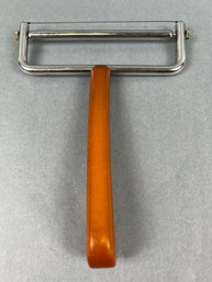 Vintage Amber Bakelite Handled Cheese Slicer.