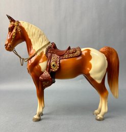 Brown And White Horse With Brown Saddle
