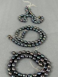 Three Strands Of Black Pearls