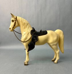 Large White Horse With Black Saddle