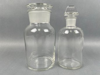 2 Apothecary Jars With Stoppers One Is Marked Pyrex S-19.