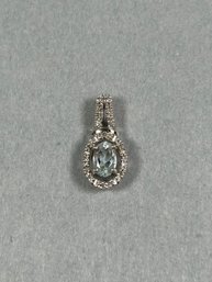 10K White Gold Pendant With Diamonds Surrounding Light Blue Faceted Stone