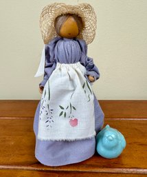 Wooden Doll And Small Porcelain Bird