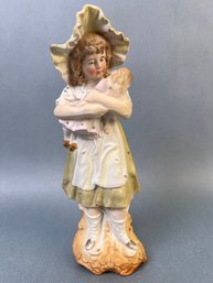 Vintage Bisque Porcelain Figurine Of A Girl With Her Doll.