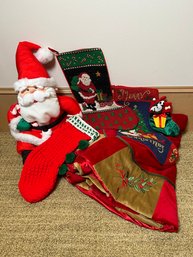 Grouping Of Christmas Stockings, Tree Skirt And Santa