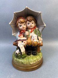 Possible Hummel Ceramic Statue Of 2 Children And 2 Puppies.