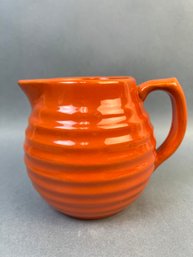 Orange Glazed Ceramic Pitcher.