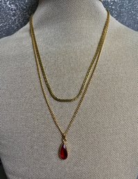 2 Gold Necklaces -one Has A Red Stone