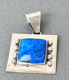 Sterling Pendant With A Blue Stone.