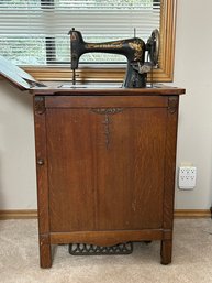 The Free Treadle Sewing Machine In Oak Cabinet