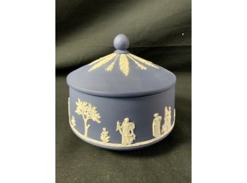 Wedgwood Jasperware Jar. Surrounded With White Figures. Top Has White Decorations.