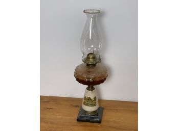 Antique Oil Lamp With A Iron Base And Cottage Scene