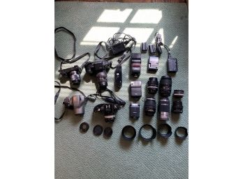 Large Grouping Of Cameras Including Lenses. Names Like Pentax, Sony, Olympus, And Others