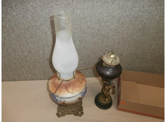 2 Oil Lamps, 1 With Children And A Cat And Dog, And 1 Is Pot Metal Figural With Ruby Red Glass
