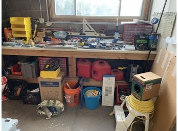A Contents Of A Work Bench Full Of Tools And Other Miscellaneous Items