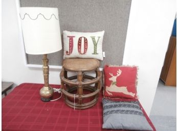 An Assortment Of Home Decor Including India Brass Tall Lamp, Rattan Accent Table And 3 Pillows