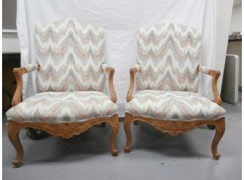A Pair Of Upholstered French Style Arm Chairs With Stylized Acanthus Leaf And Other Carved Elements