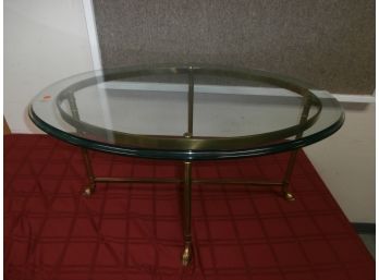 Oval Glass Top Cocktail Table With Brass Base And Hoof Feet