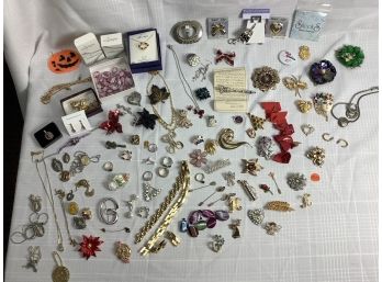 A Large Mixed Lot Of Costume Jewelry Including Pins, Necklaces, Rings, Religious Items And More