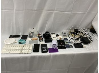 Large Electronics Lot Including Assorted Cords, IPhone, Power Packs, Fit Bit, Apple Keyboard And More