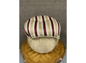 UPHOLSTERED ROUND FOOTSTOOL WITH RED AND TAN UPHOLSTERY