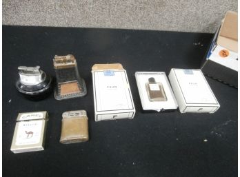 An Assorted Lot Of A Perfume And Lighters