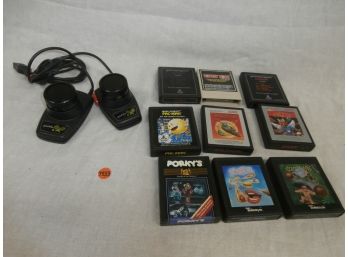 9 Atari 2600 Cartridges Including Porky's, Fast Food, Coconuts And A Pair Of Atari 2600 Paddle Controllers