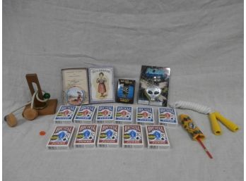 Game Lot Including 11 Sealed Sets Of Playing Cards, Brain Teasers, Etc.