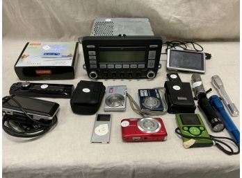 Electronic Lot Including A VW Radio, Radio Faceplate, Cameras, GPSs And More