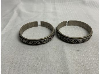 A Pair Of Silver Carved Oriental Bangle Bracelets