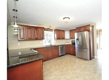 Forever Mark Custom Cherry Kitchen Cabinets With A Dark Granite Counter Tops And Stainless Sink