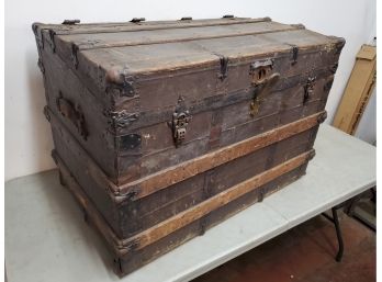 Antique Cutter & Cutter Oak And Metal Bound Metal Bottomed Trunk With Angled Lid And Casters