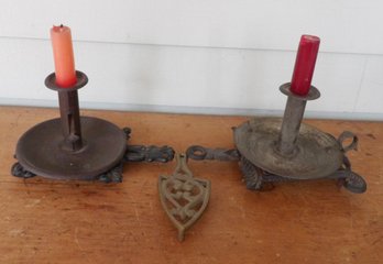 THREE EARLY SAUCER BASED CANDLE HOLDERS AND CAST IRON TRIVETS