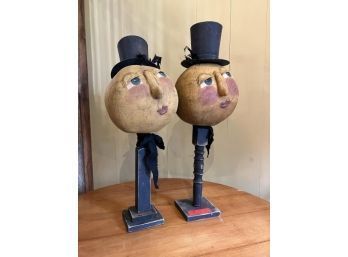 Pair Of Humpy Dumpty Heads On Wooden Poles